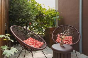 two wicker chairs sitting on a patio with a table at Pretty Jolie Romantic Getaway in Bled
