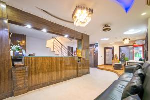a lobby of a restaurant with a couch and a bar at Hotel Anand - Near Ganga Ram & BLK Hospital At Karol Bagh Metro Station in New Delhi