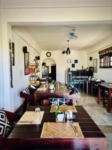 a restaurant with tables and chairs in a room at Seagreen Guesthouse - Galle Fort in Galle +35 photos
