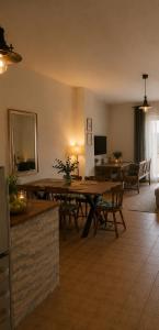 a living room with a wooden table and chairs at Apartments Alma in Pag