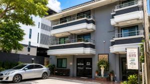 a car parked in front of a building at Fortune Pattaya Resort in Jomtien Beach