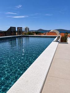 a swimming pool on top of a building at Apartments Maritea in Vodice