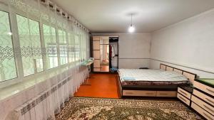 a bedroom with two beds and a large window at NomadicaKyrgyz in Tërt-Kul'