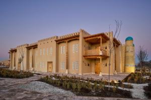 a building with two towers on the side of it at Arda Angariki in Khiva