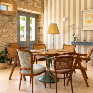 a dining room with a wooden table and chairs at Hotel Heritage Casa Blanka in Makarska