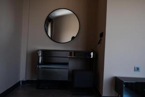 a mirror on the wall above a dresser in a bathroom at Belek Seven Luxury in Belek +26 photos