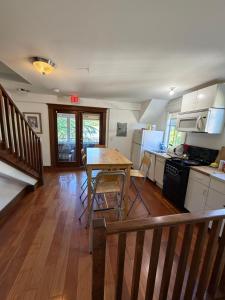 a kitchen with a table and chairs in a room at Cambie Guestshouse in Vancouver