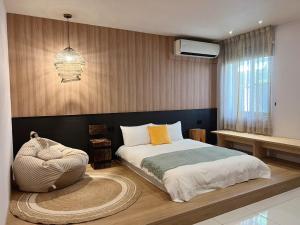 a bedroom with a king sized bed and a rug at Ho.Me-Easyhouse in Tainan