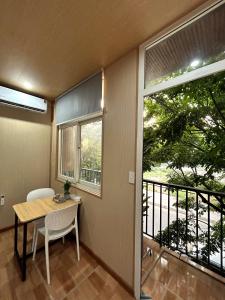 a dining room with a table and a balcony at Linh's House in Danang