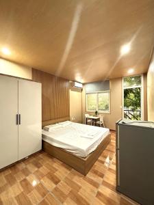 a bedroom with a large bed in a room at Linh's House in Danang