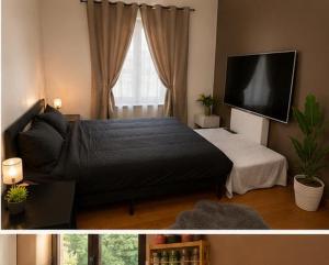 a bedroom with a bed and a flat screen tv at Citadelle Liège Centre in Liège