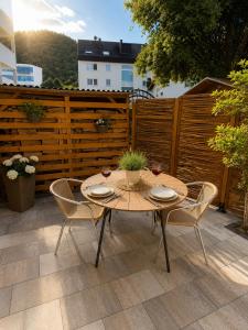 a wooden table and chairs on a patio at Ferieneleganz am Fluss in Bad Ems