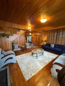 a living room with a couch and a table at Haven Hilltop Cottage, Dunga Gali in Dunga Gali