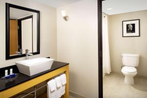 a bathroom with a sink and a toilet at Best Western Alamo Suites Downtown in San Antonio
