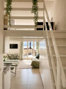 a living room with stairs and a living room with a couch at Casa PG - Appartamento Vista Lago in Monte Isola