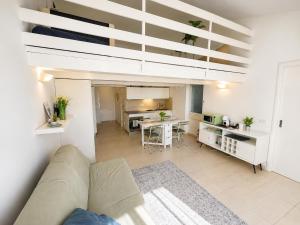 a living room with a couch and a loft bed at Casa PG - Appartamento Vista Lago in Monte Isola