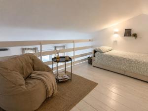 a living room with a chair and a bed at Casa PG - Appartamento Vista Lago in Monte Isola +36 photos