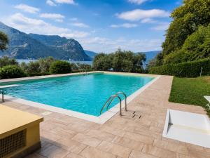 a swimming pool with a view of the mountains at Casa PG - Appartamento Vista Lago in Monte Isola