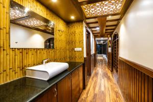 a bathroom with a sink and wooden walls at Southern Panorama Houseboats in Alleppey