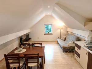 a living room with a table and a couch at Apartment Cankar's View in Vrhnika