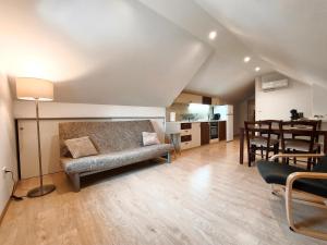 a living room with a couch and a table at Apartment Cankar's View in Vrhnika