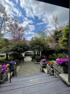 a garden with flowers on a wooden walkway at Cambie Guestshouse in Vancouver