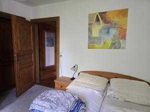a bedroom with a bed and a lamp on a table at idyllisches Mühlengebäude in Hillesheim
