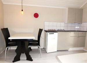 a kitchen with a table and chairs and a red balloon at Sona Camping in Hegra