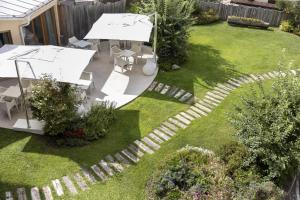 an overhead view of a garden with a table and umbrella at Blu Hotel Natura & Spa - Adults Only in Folgaria