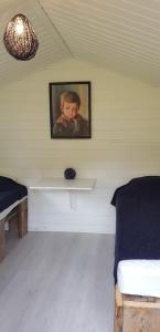 a room with a painting of a woman on the wall at Sona Camping in Hegra +20 photos