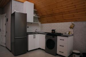 a kitchen with a refrigerator and a washing machine at Family House Quba, Guba, Qeçreş,Qəçrəş,Qecresh in Qǝçrǝş +25 photos