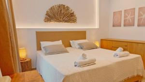 a bedroom with a large bed with towels on it at Hotel Zafira in Skala Rachoniou +55 photos