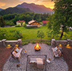 a fire pit in the middle of a backyard with a view at Tourist Farm Kranjc in Kobarid