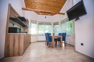 a kitchen and dining room with a table and chairs at Complex Perpera in Stambolovo