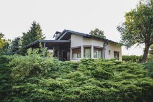 a house on a hill surrounded by trees at Complex Perpera in Stambolovo