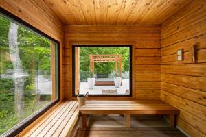 a sauna with a window in a wooden cabin at Avalon Resort & SPA in Miskolctapolca