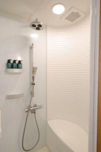 a bathroom with a shower with a shower head at 栞-shiori-NAKASONE in Miyako-jima
