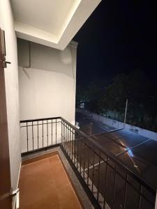 a balcony with a view of a tennis court at night at coastal coral in Tirupporūr