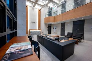 an office with a couch and tables and chairs at Jamsil Hotel Vene in Seoul
