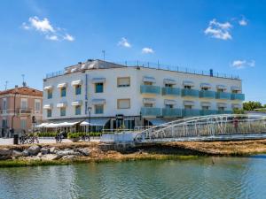 a bridge over the water in front of a building at Hotel Excelsior in Fano