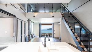 a staircase in a house with a view of the ocean at LIFEMENT GLANZ Okimi in Etajima +107 photos