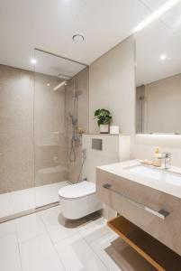 a bathroom with a toilet and a shower and a sink at La Vie on JBR in Dubai +31 photos