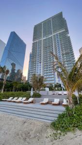 a row of lounge chairs in front of a building at La Vie on JBR in Dubai