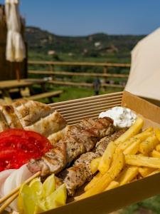 a box of food with french fries and meat at Wild Cretan West in Drakiana +16 photos