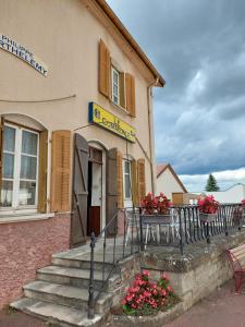 a building with a table in front of it at Le Commerce in Bulgnéville