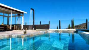 a swimming pool in front of a house at JVG VILLAS - Villa Joval in Güimar