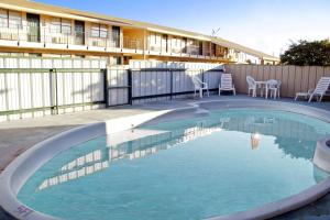 a large swimming pool in front of a building at Best Western Caprock Inn in Brownfield