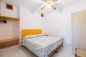 a bedroom with a bed and a ceiling fan at Agriturismo Millepini in Peschici