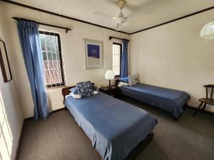 a hotel room with two beds and a window at Peter Pan Place in Port Edward +207 photos