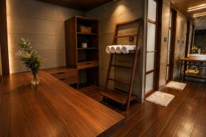 a room with a table and a shelf with towels at Southern Panorama Houseboats in Alleppey +56 photos
